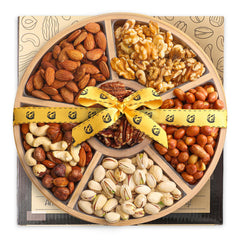 Artisanal Cravings gourmet nuts platter on round wooden board, ready for gifting.