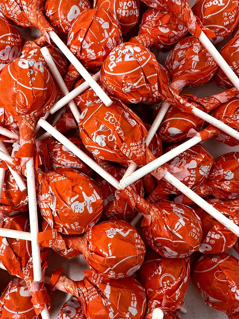 Assortit Orange Tootsie Pops at holiday tables for sweet sharing