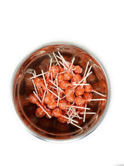 Assortit Orange Tootsie Pops in treat bags for festive favors