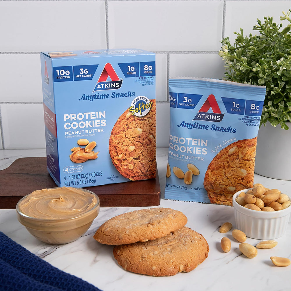 Cookie next to lunchbox signals convenient midday protein snack.