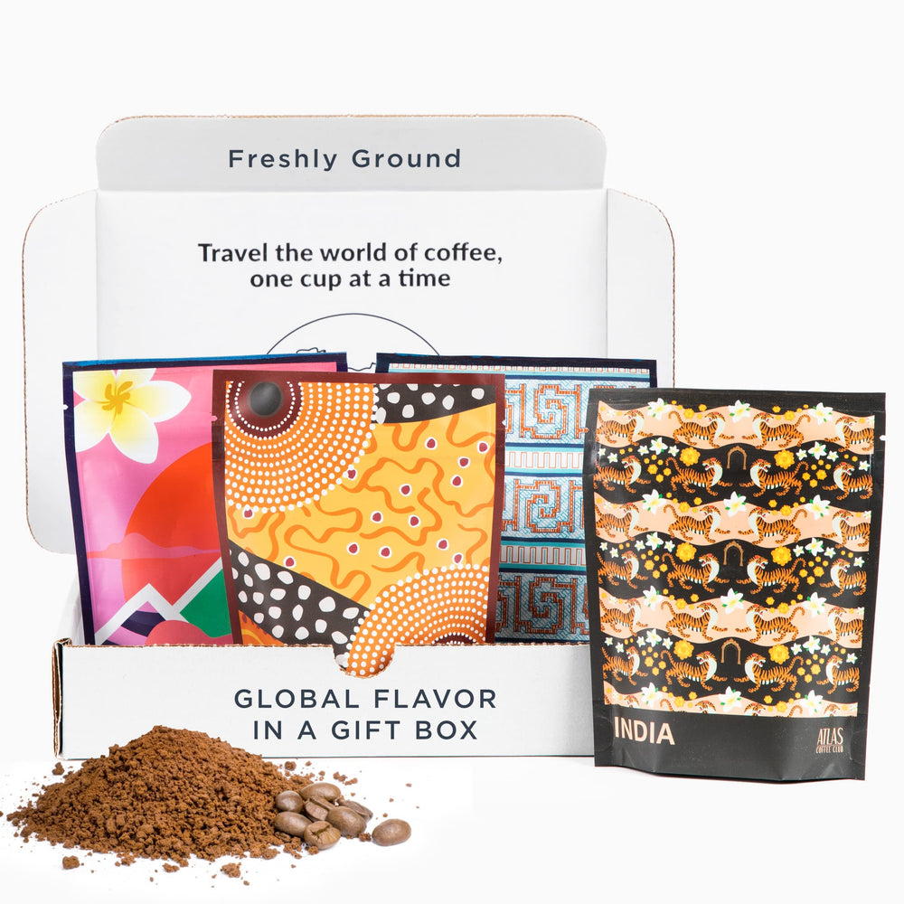 Atlas Coffee Club World Tour box featuring four coffees and postcards for a guided tasting.