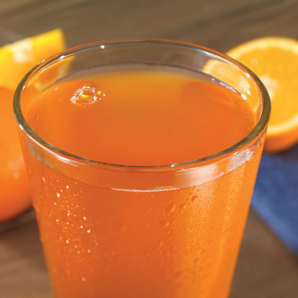 Outdoor camping scene with Orange Delight ready in water.