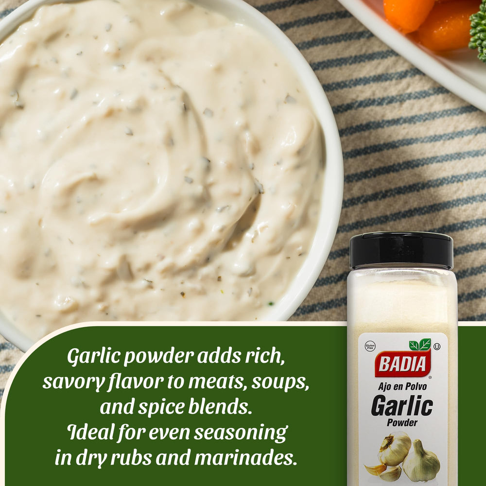 Measuring Badia Garlic Powder with a spoon for precise seasoning.