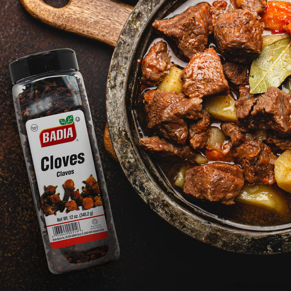Badia whole cloves being used in cooking to deepen flavor.