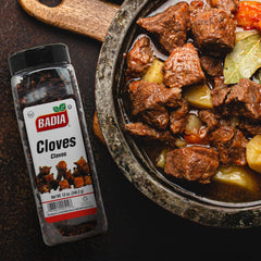 Badia whole cloves being used in cooking to deepen flavor.