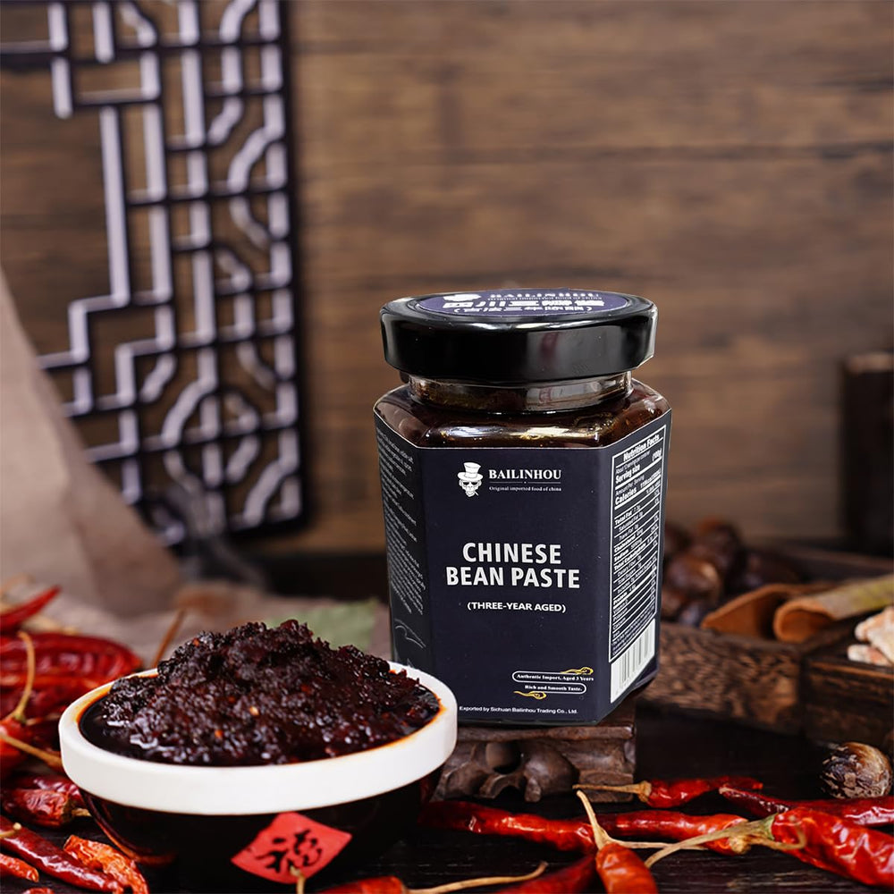 BAILINHOU premium chili paste ingredients on display with soybeans and peppers.