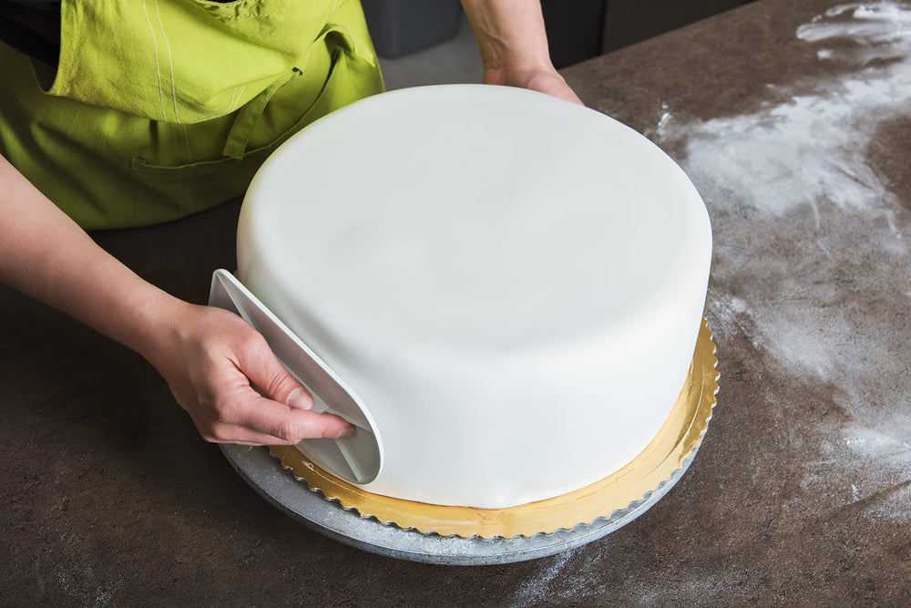 Bakerpan Premium Rolled White Fondant covering a cake for a seamless finish.