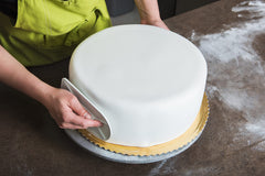 Bakerpan Premium Rolled White Fondant covering a cake for a seamless finish.