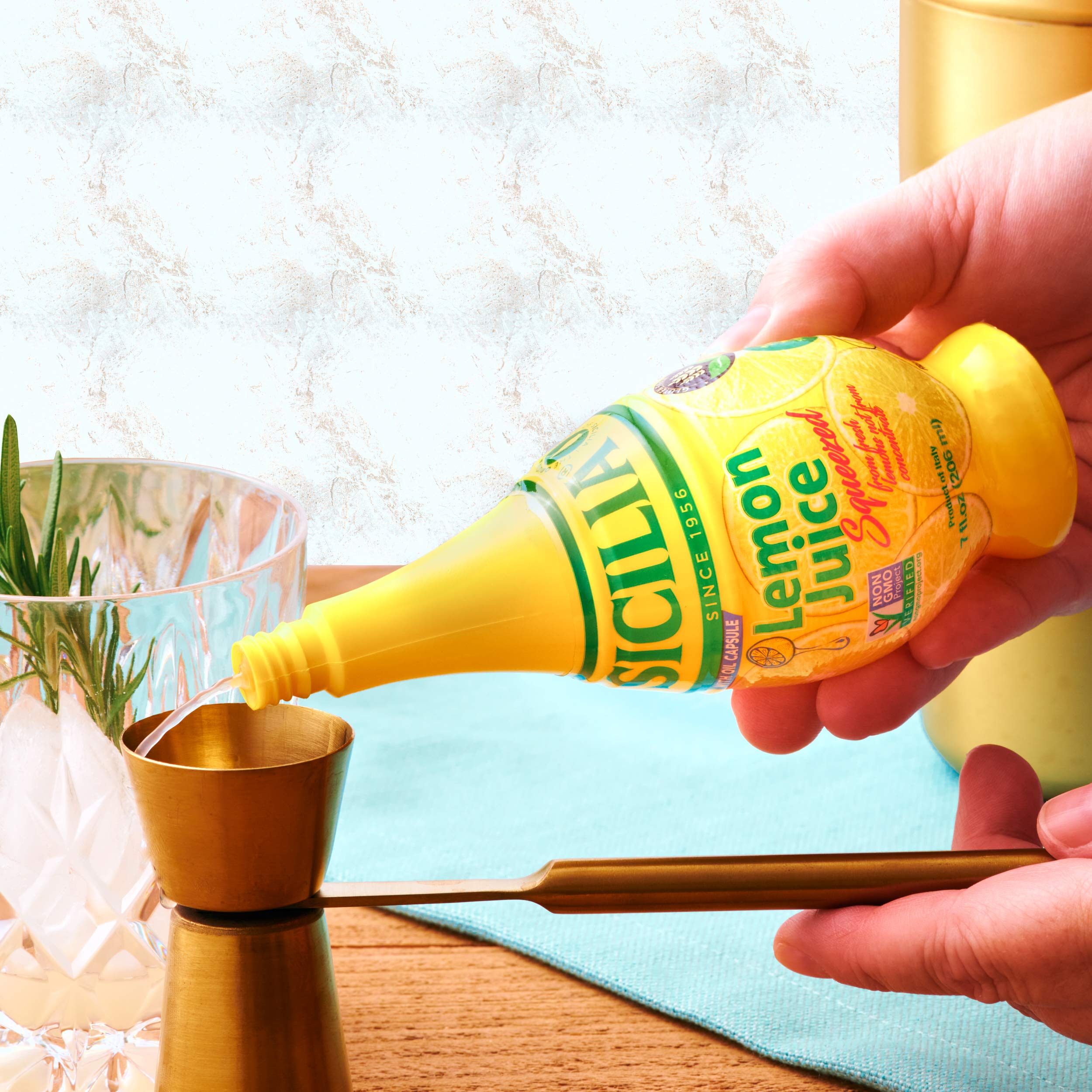 BANRIN Sicilia Lemon Juice bottle being squeezed over a salad for bright flavor.