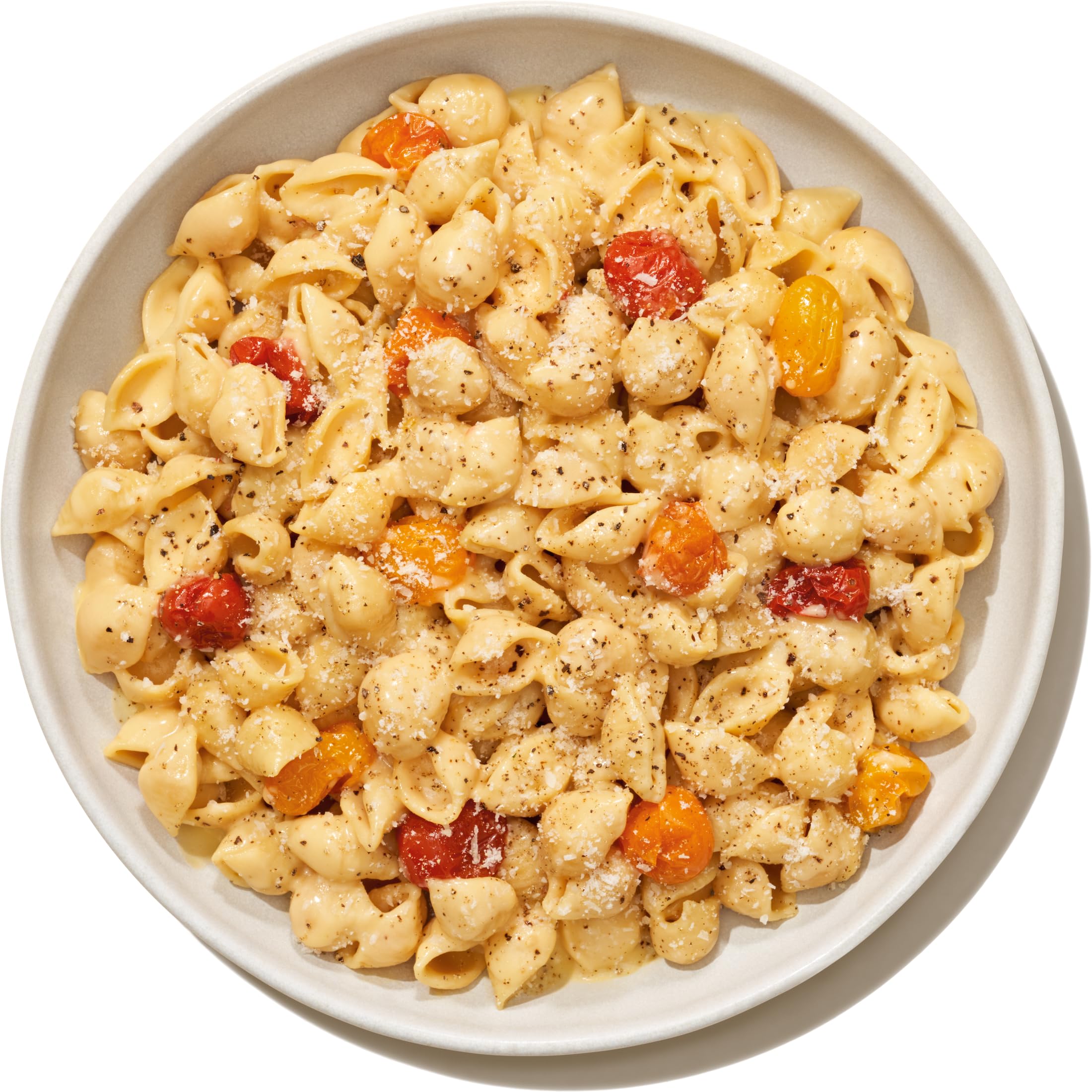 Banza serving plate shows vibrant pasta dish with creamy sauce.