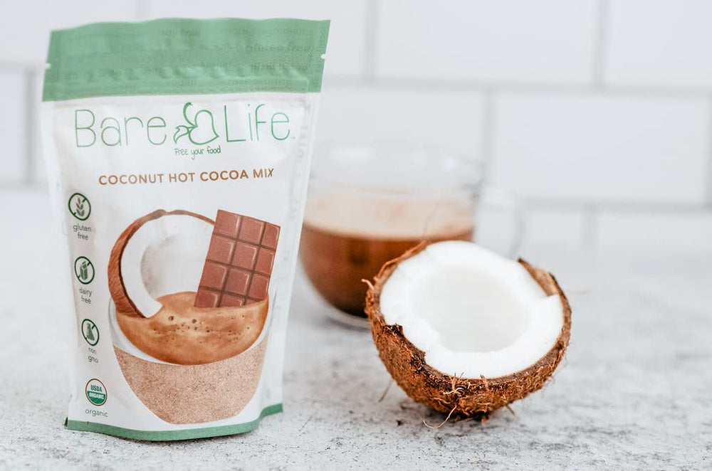 Bare Life hot cocoa ready in a mug with a dairy-free swirl