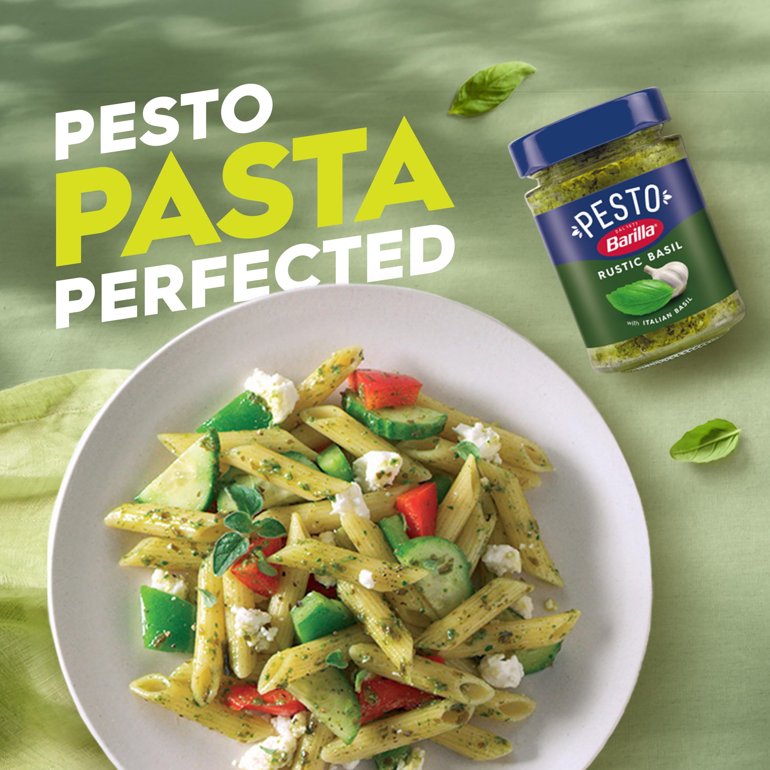 Ingredients close-up highlighting basil and cheese in Barilla pesto.