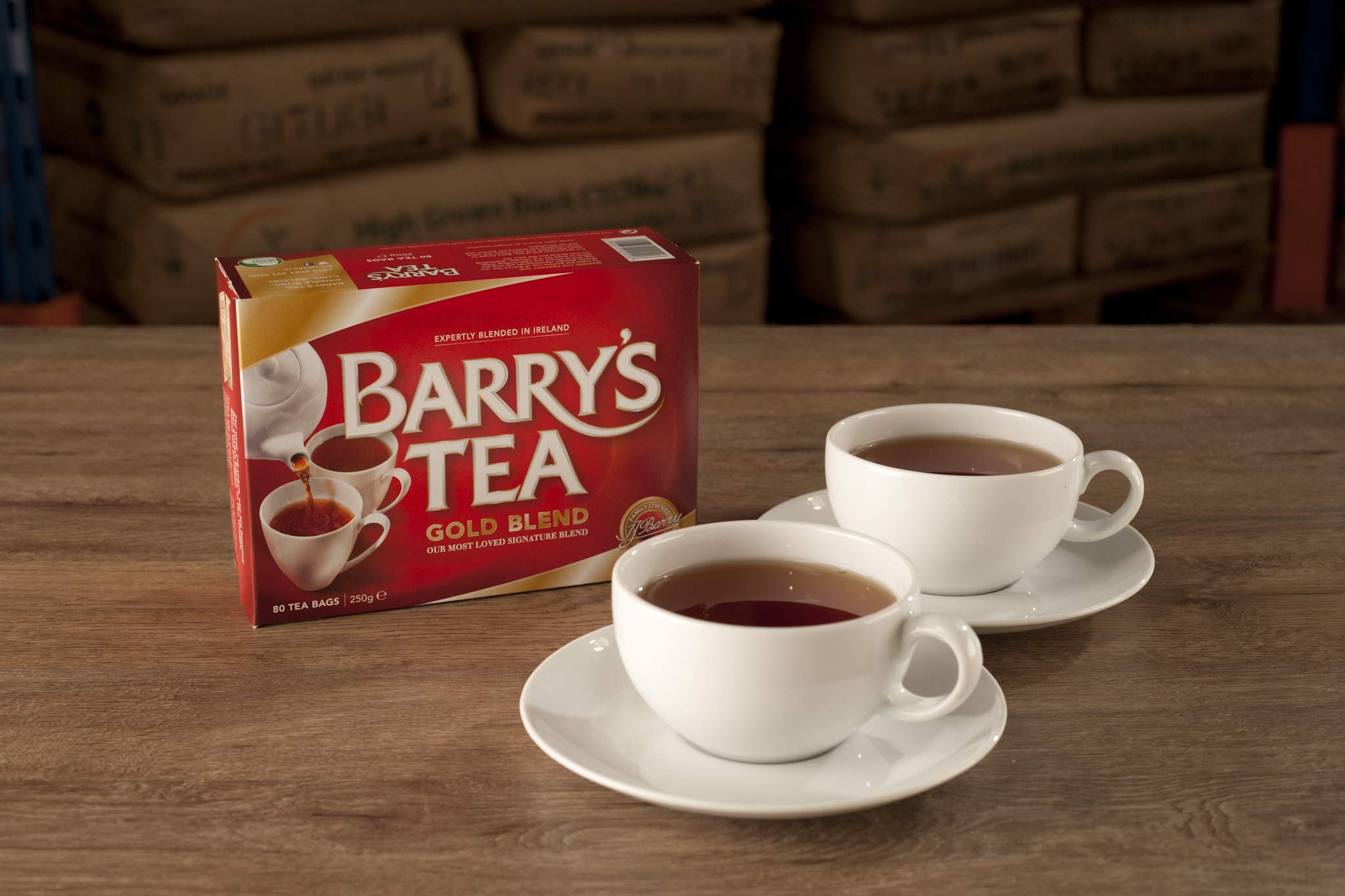 Barry's Tea Gold Blend product shot with scattered tea leaves, highlighting premium blend notes