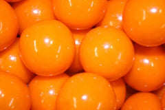 Bayside Candy orange gumballs 1-inch closeup, perfect for bright candy displays.