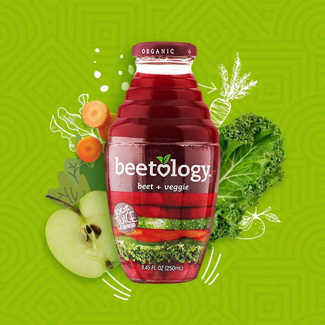 Beetology glass of vibrant juice on a table highlights color and hydration.