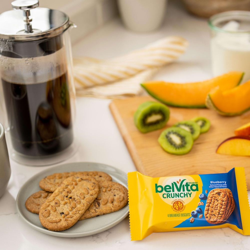 Mid-morning snack of Belvita blueberry biscuits at desk with notebook.