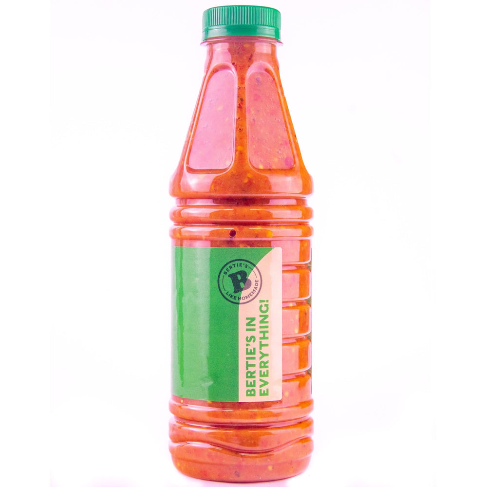 Bertie's Original Pepper Sauce bottle with fresh peppers suggests ready-to-use flavor boost.