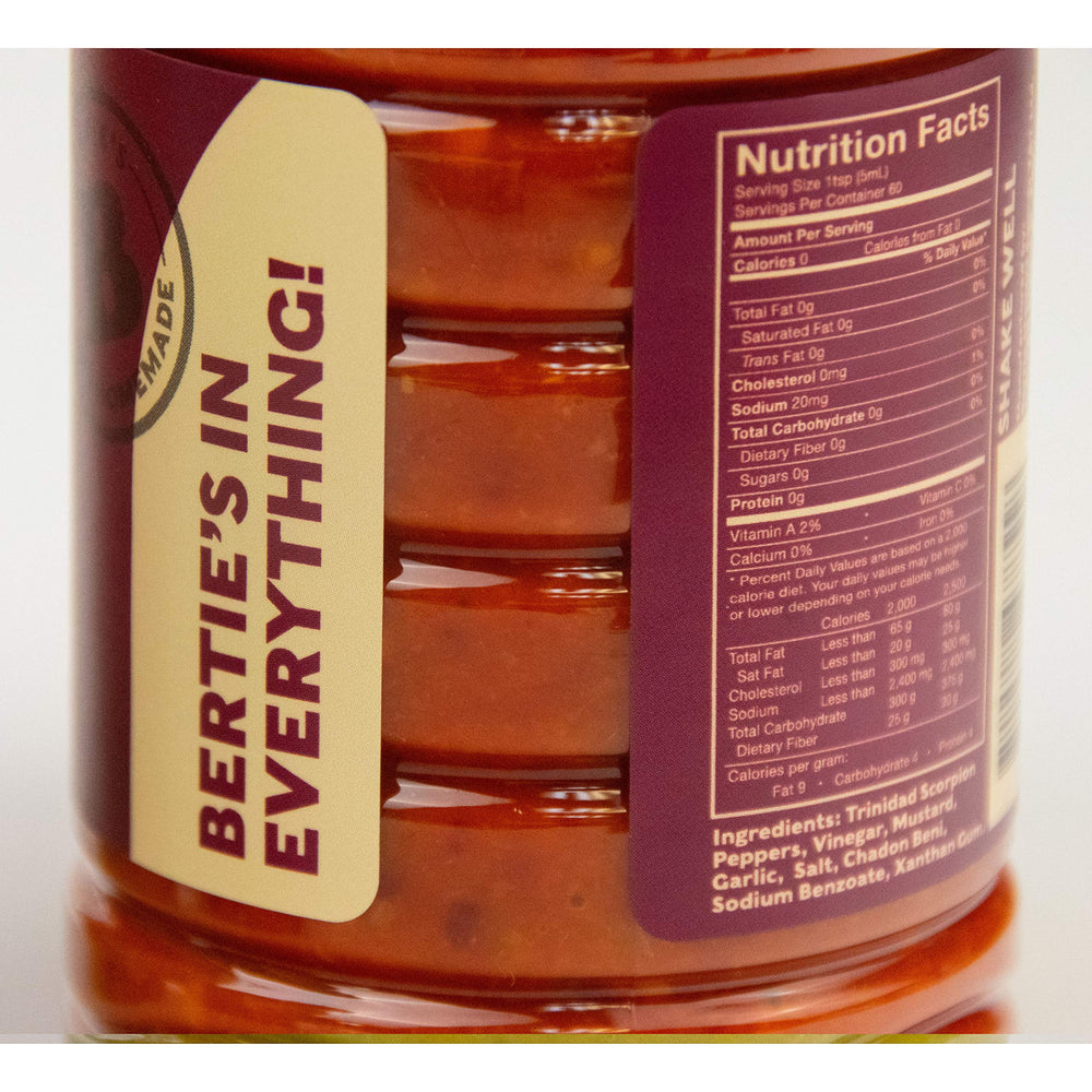Bertie's Trinidad Scorpion Pepper Sauce pour shot showing intense aroma and heat release.