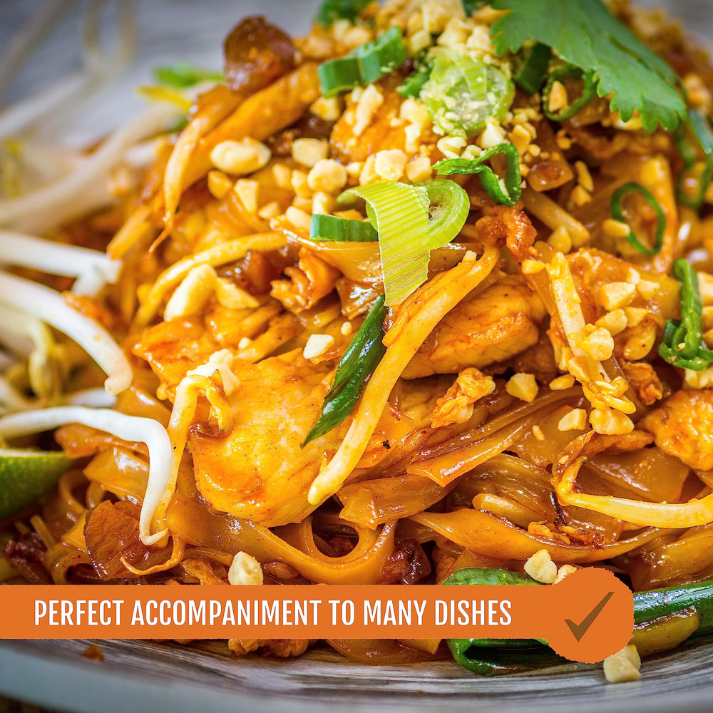 Glass bowl with Best of Thailand Pad Thai Sauce over noodles for a rich finish