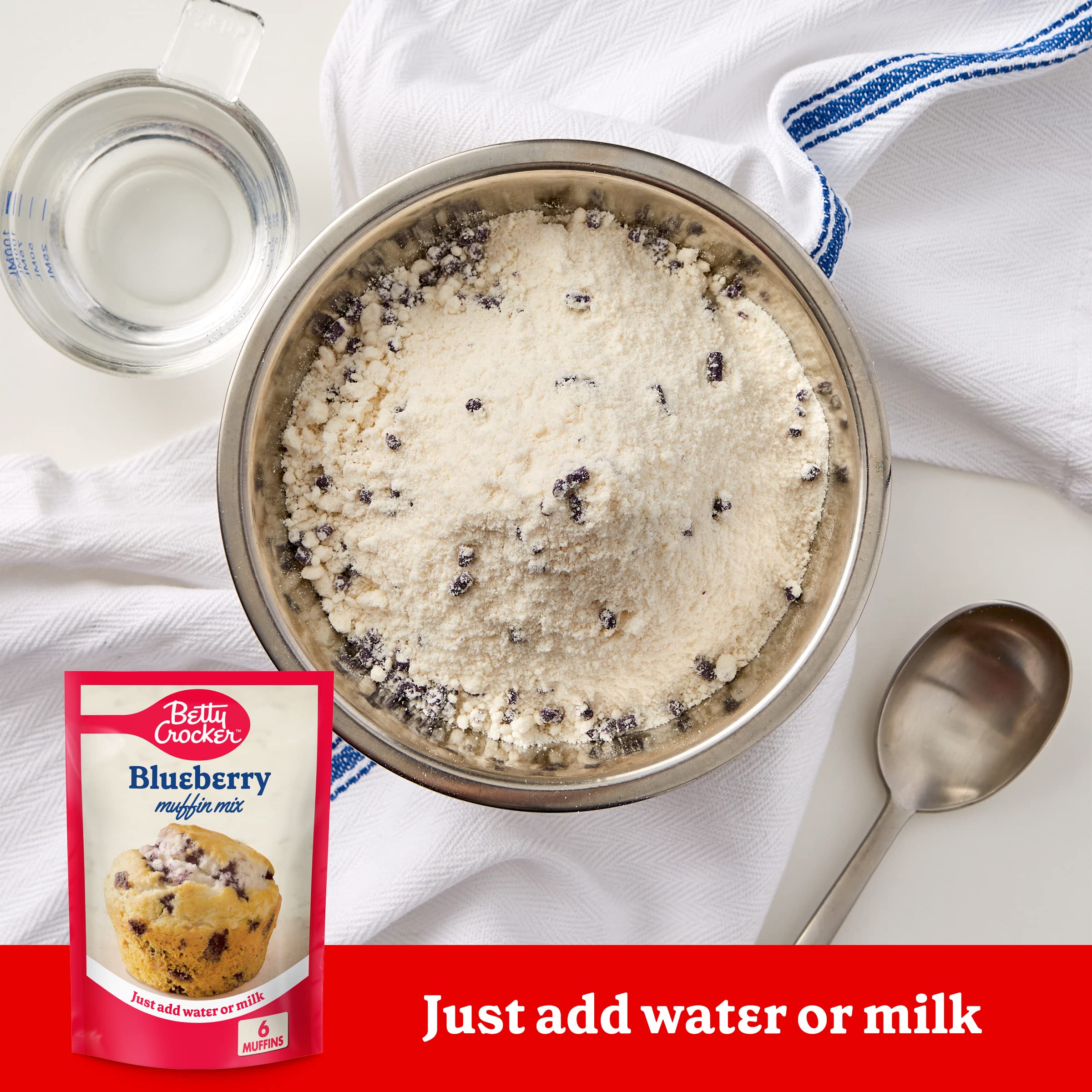 Betty Crocker Blueberry Muffin Mix batter poured into tin for golden tops.