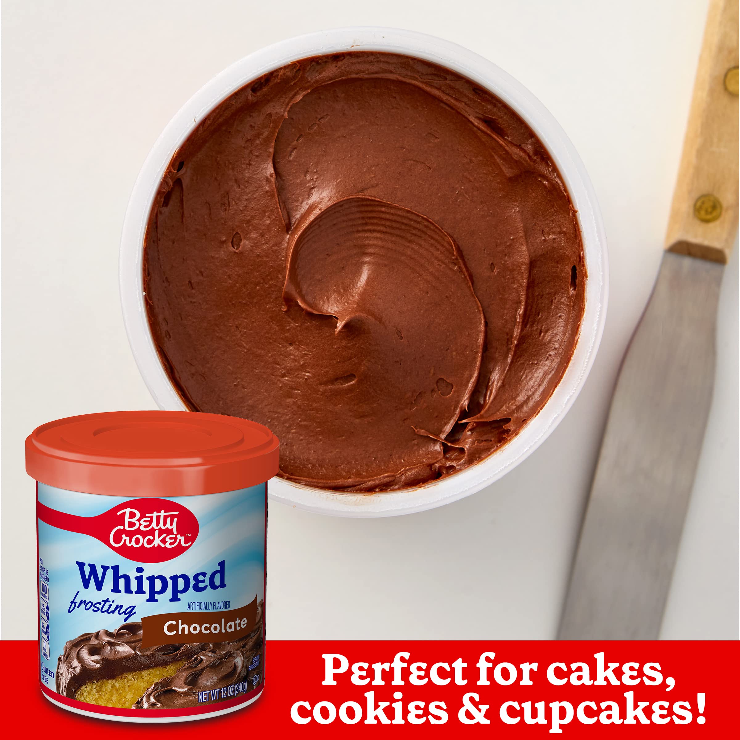 Betty Crocker Whipped Chocolate Frosting swirled on cupcakes with decorative sprinkles.
