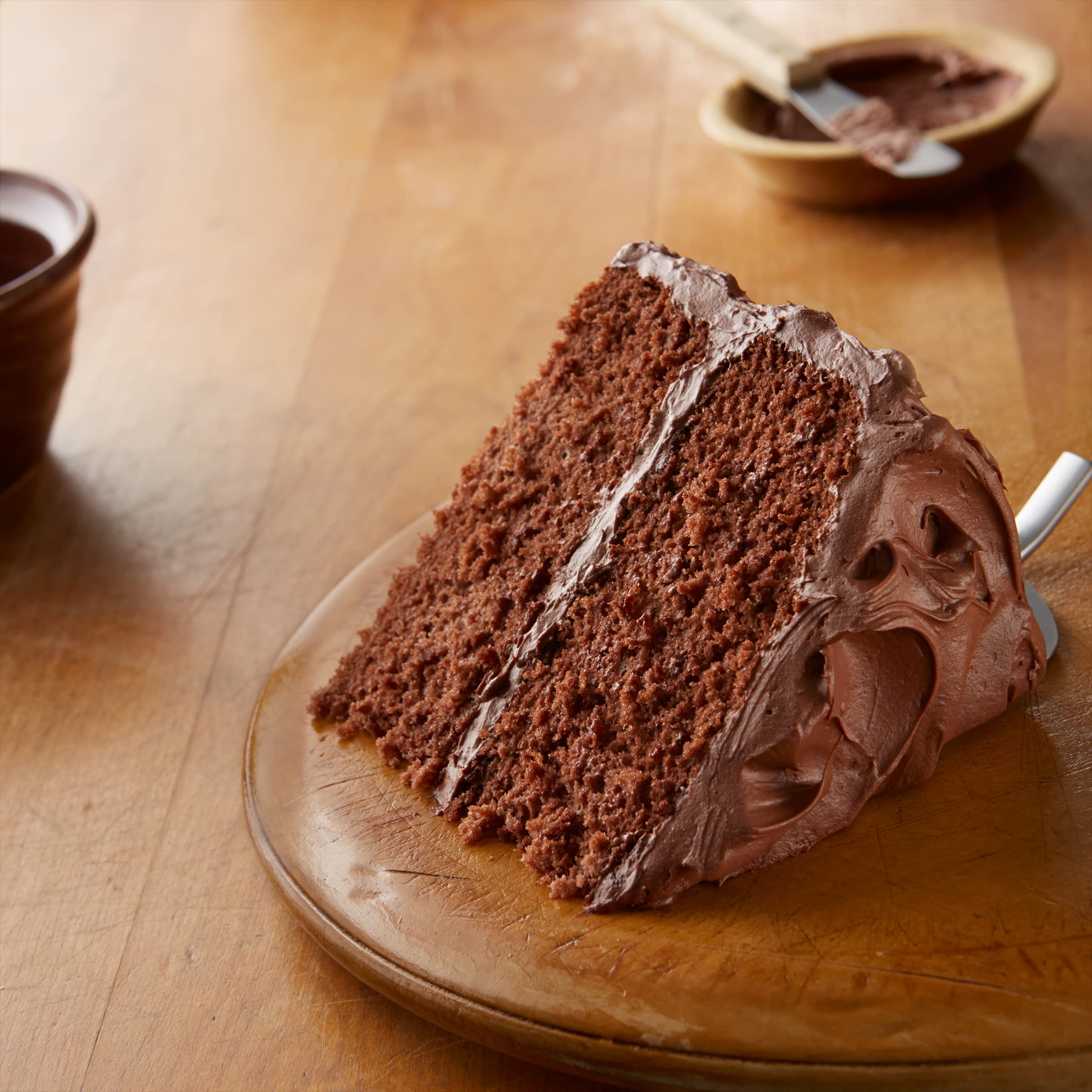 Betty Crocker Whipped Chocolate Frosting spread on a cake for a glossy finish.