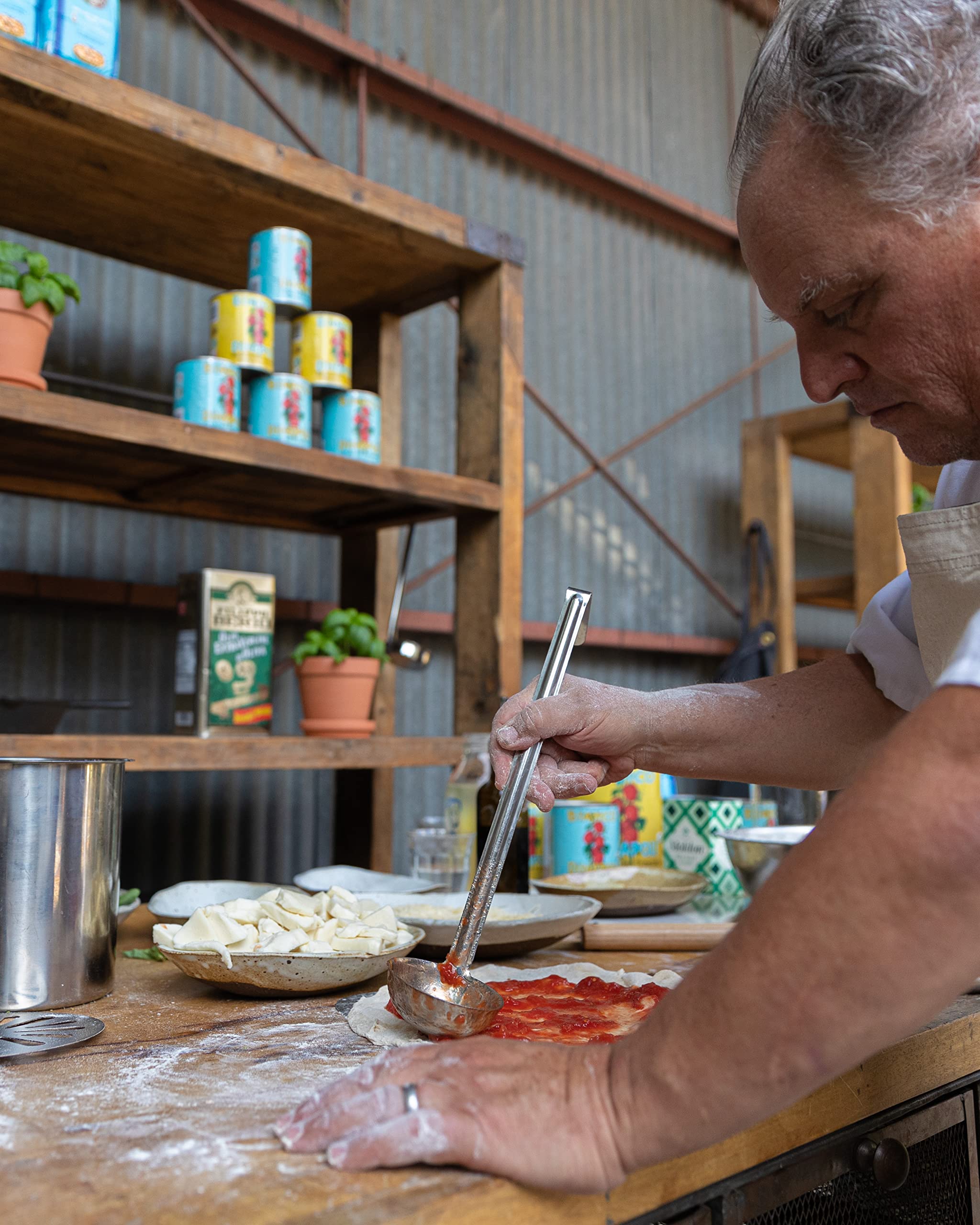 Bianco DiNapoli pizza night setup with sauce and fresh basil.