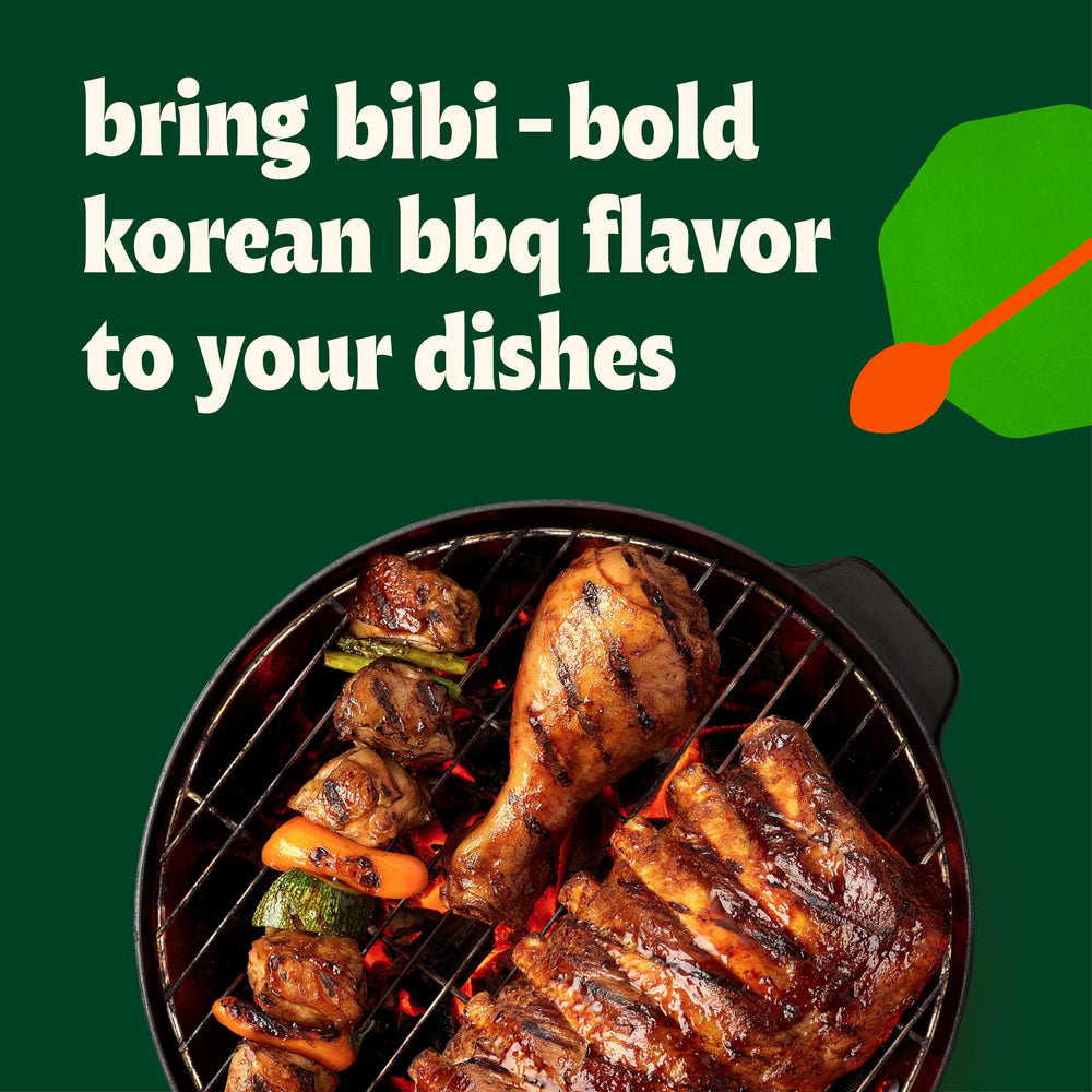 Ribs coated with Bibigo Original Korean BBQ Sauce in a close-up shot.