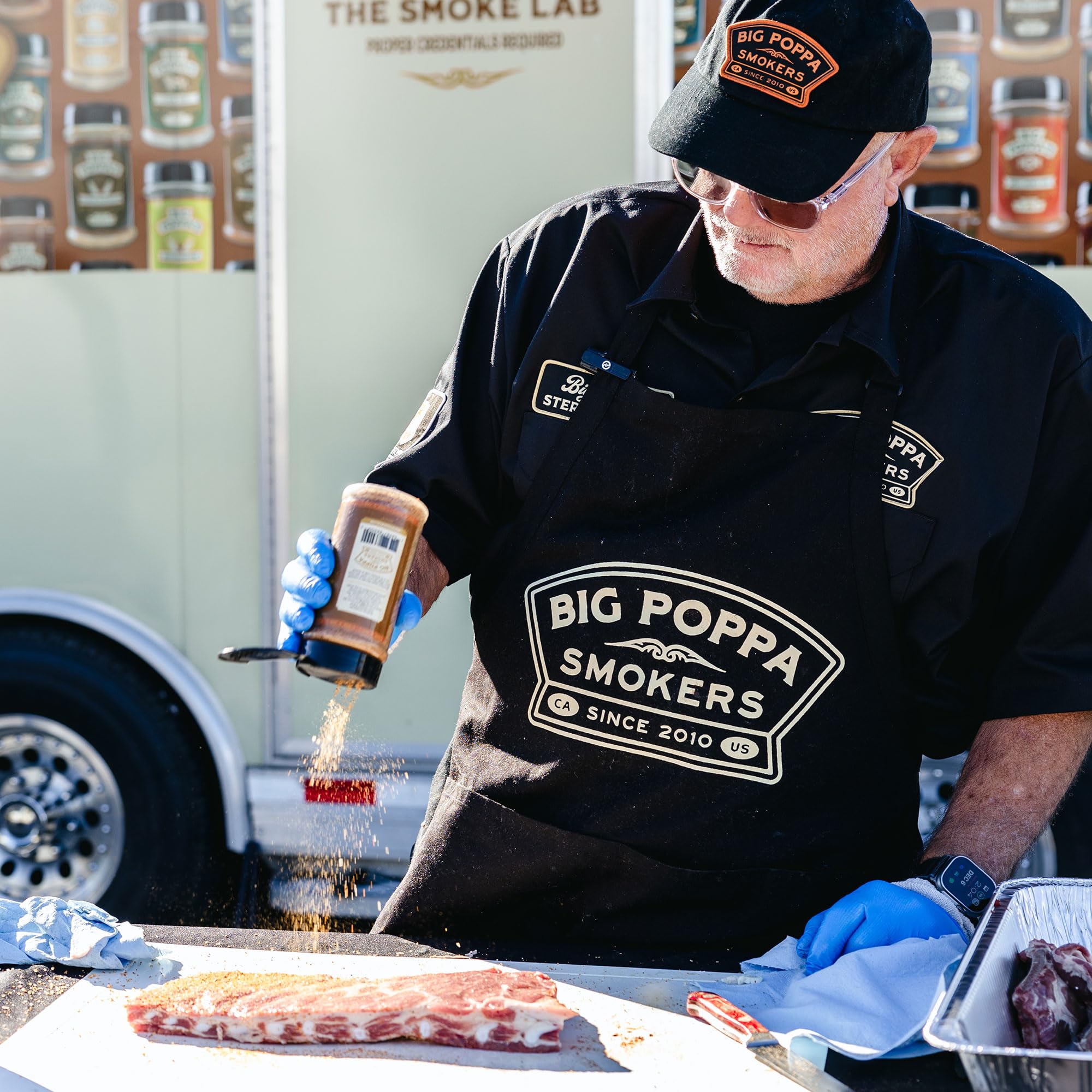 Big Poppa’s Sweet Money rub on pork ribs on grill for smoky tenderness
