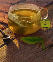 Bigelow Constant Comment Green Tea in a glass cup, smooth infusion for hot or iced enjoying.