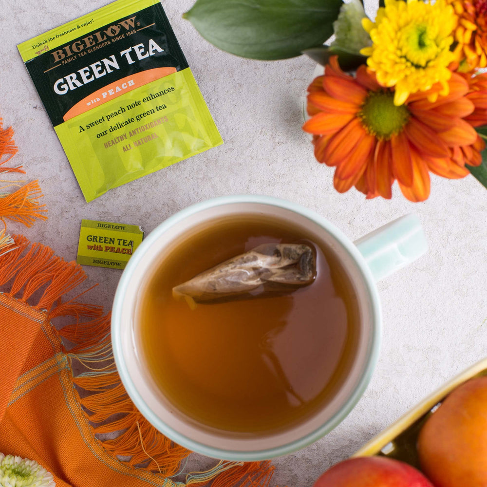 Bigelow Green Tea with Peach tea bags closeup highlighting individually wrapped freshness.