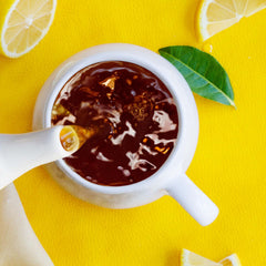 Bigelow Lemon Lift tea cup with steam, a caffeinated citrus pick-me-up.