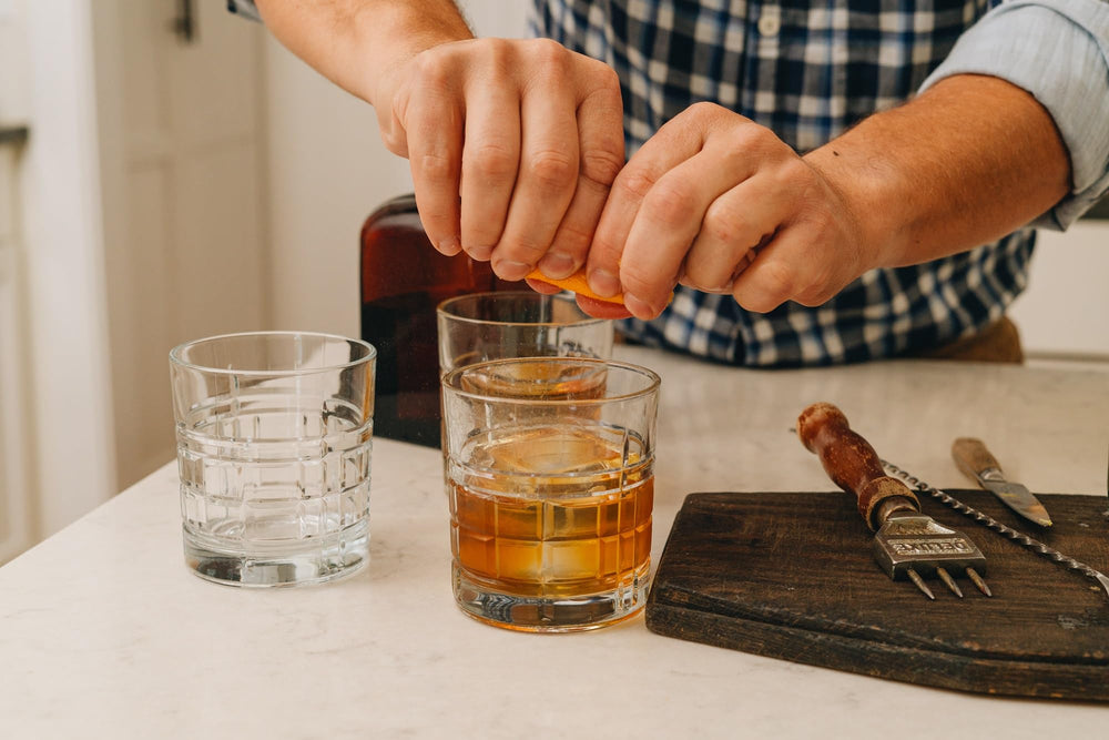 Bartender prepares Bittermilk No.1 cocktail in a glass.