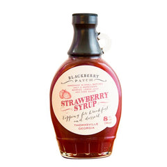 Blackberry Patch Strawberry Syrup bottle being poured over pancakes for fruity sweetness