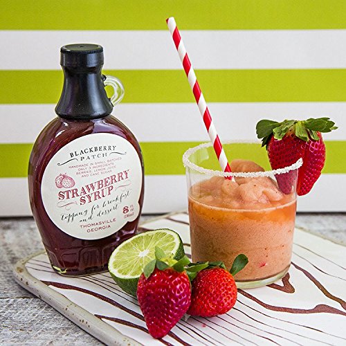 Pouring Blackberry Patch Strawberry Syrup over pancakes for dessert topping