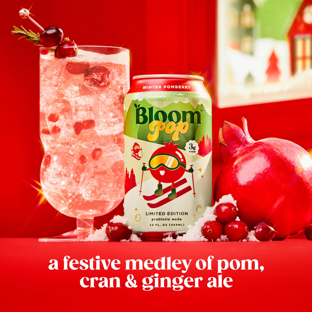 Glass pouring Bloom Pop Winter Pomberry into a glass, caffeine-free refreshment.