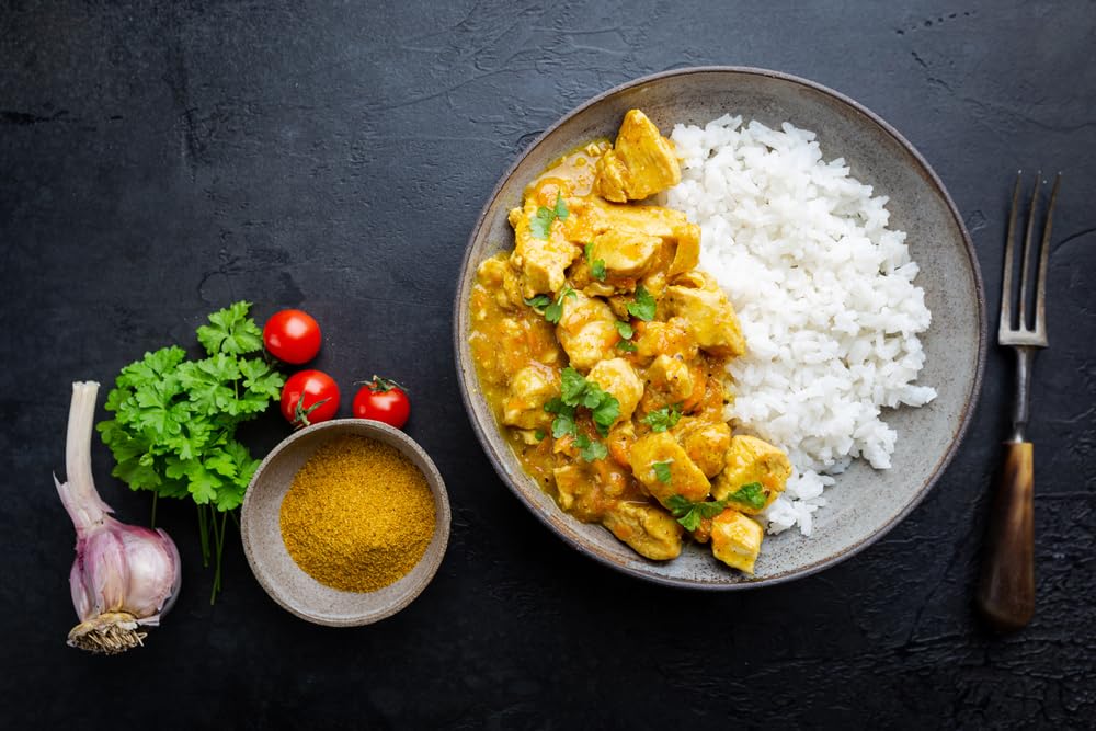 Kitchen scene featuring Blue Mountain Country Jamaican Curry Powder as a versatile spice