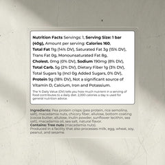Blueprint Bryan Johnson white cocoa macadamia bar half-eaten reveals creamy texture with nuts.