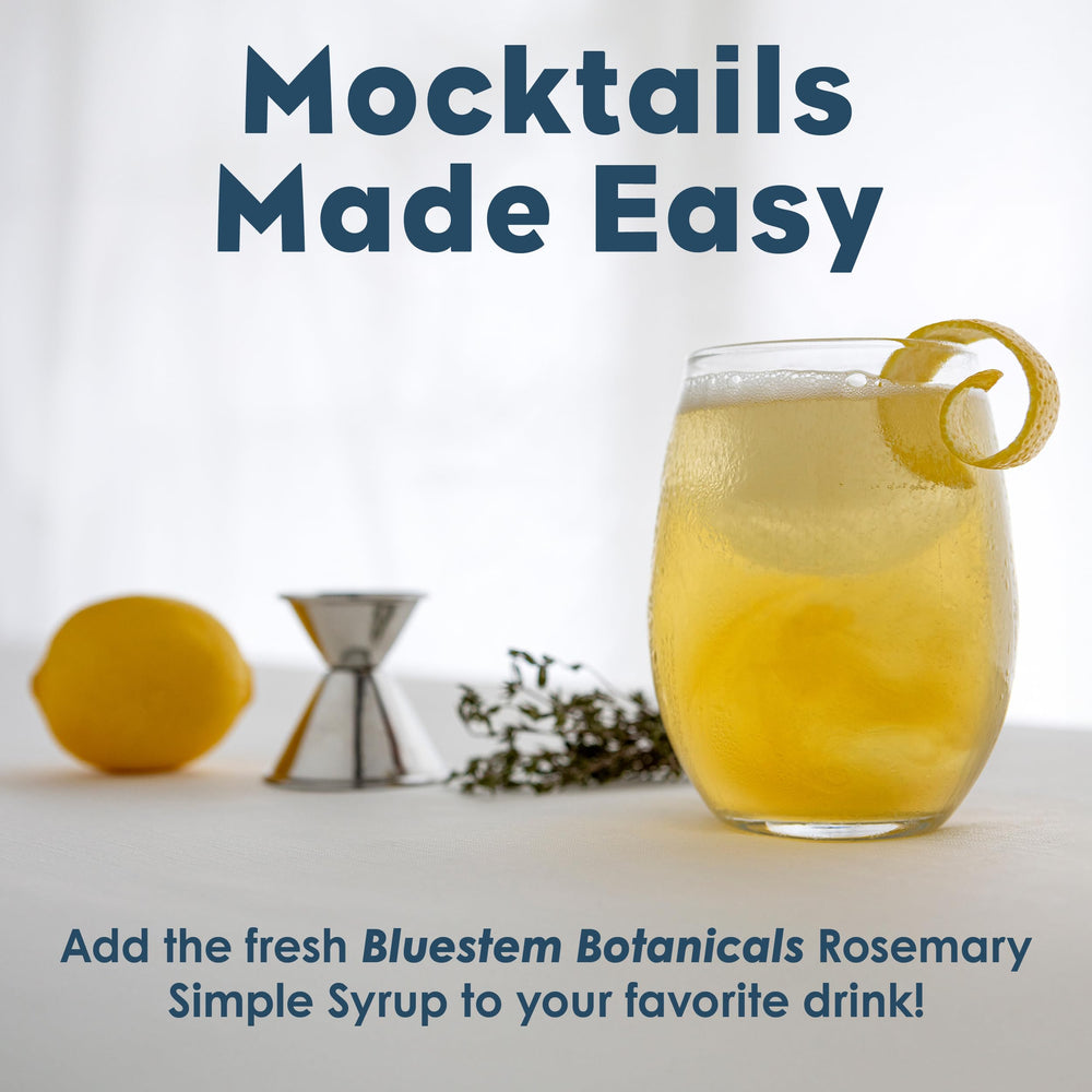 Bluestem Botanicals Rosemary Simple Syrup bottle beside a rosemary sprig for premium entertaining.