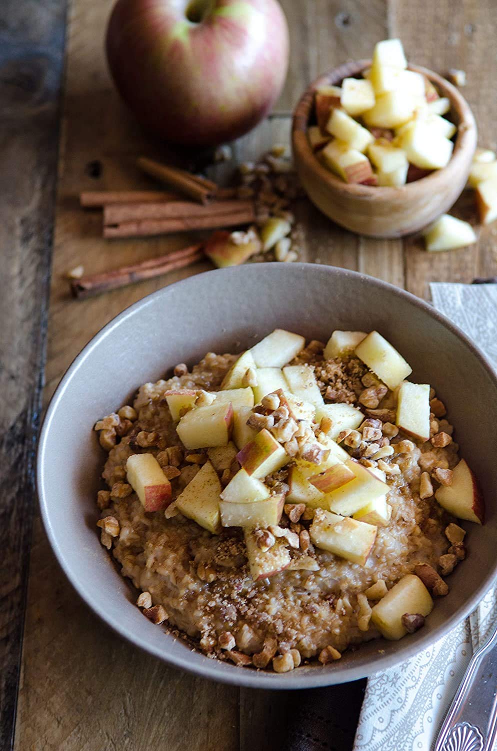 Bob's Red Mill oats in a bowl with fruits and nuts, appealing toppings.
