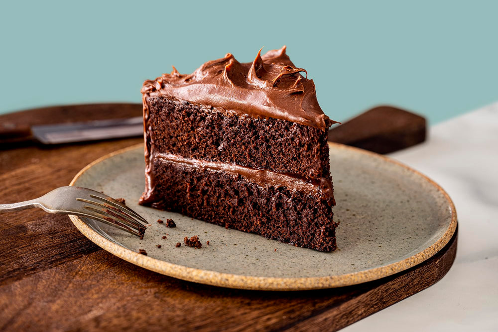 Finished slice of cake highlighting moist texture from signature four-flour blend.