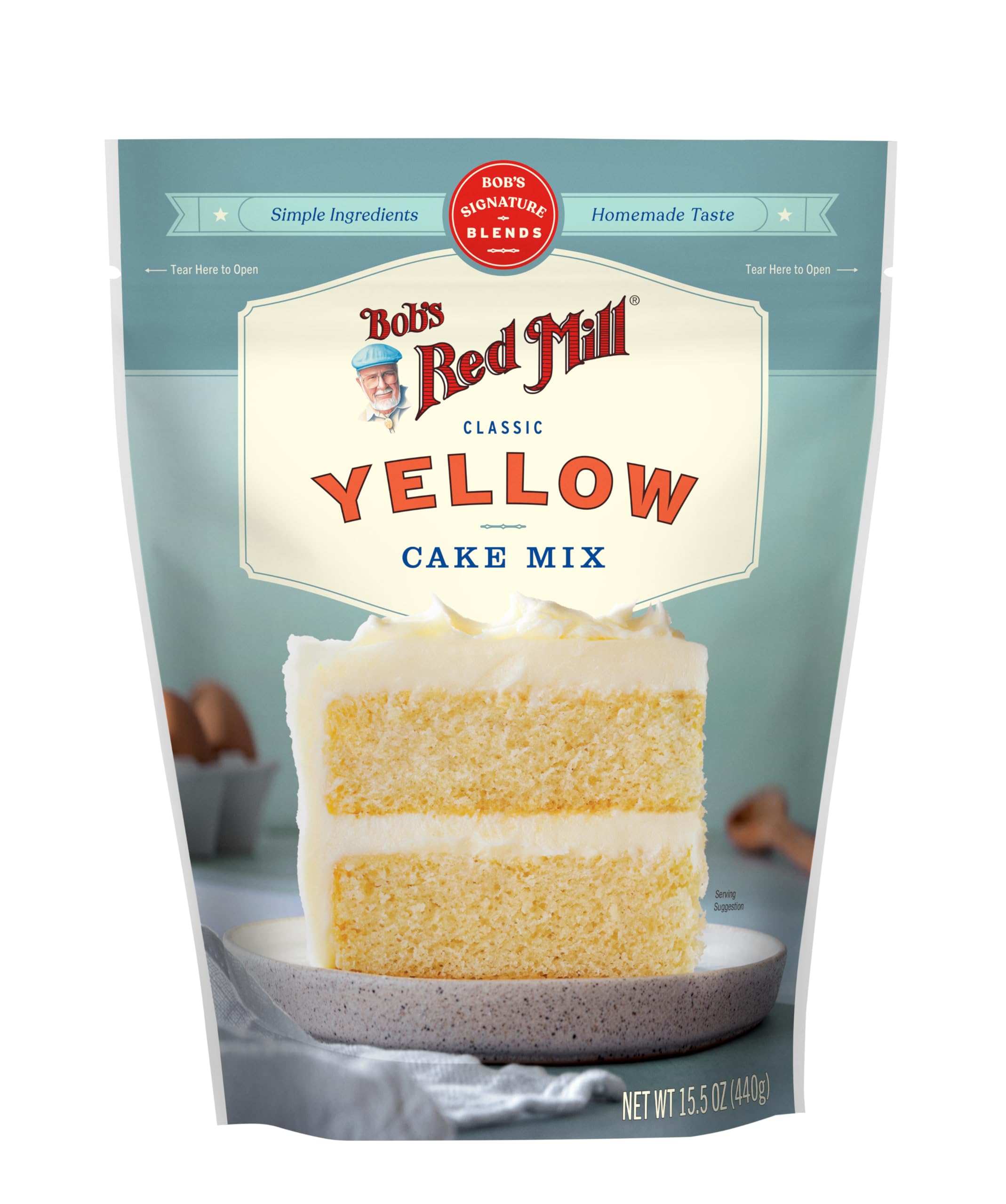Golden-brown finished cake on a stand with frosting using Bob's mix