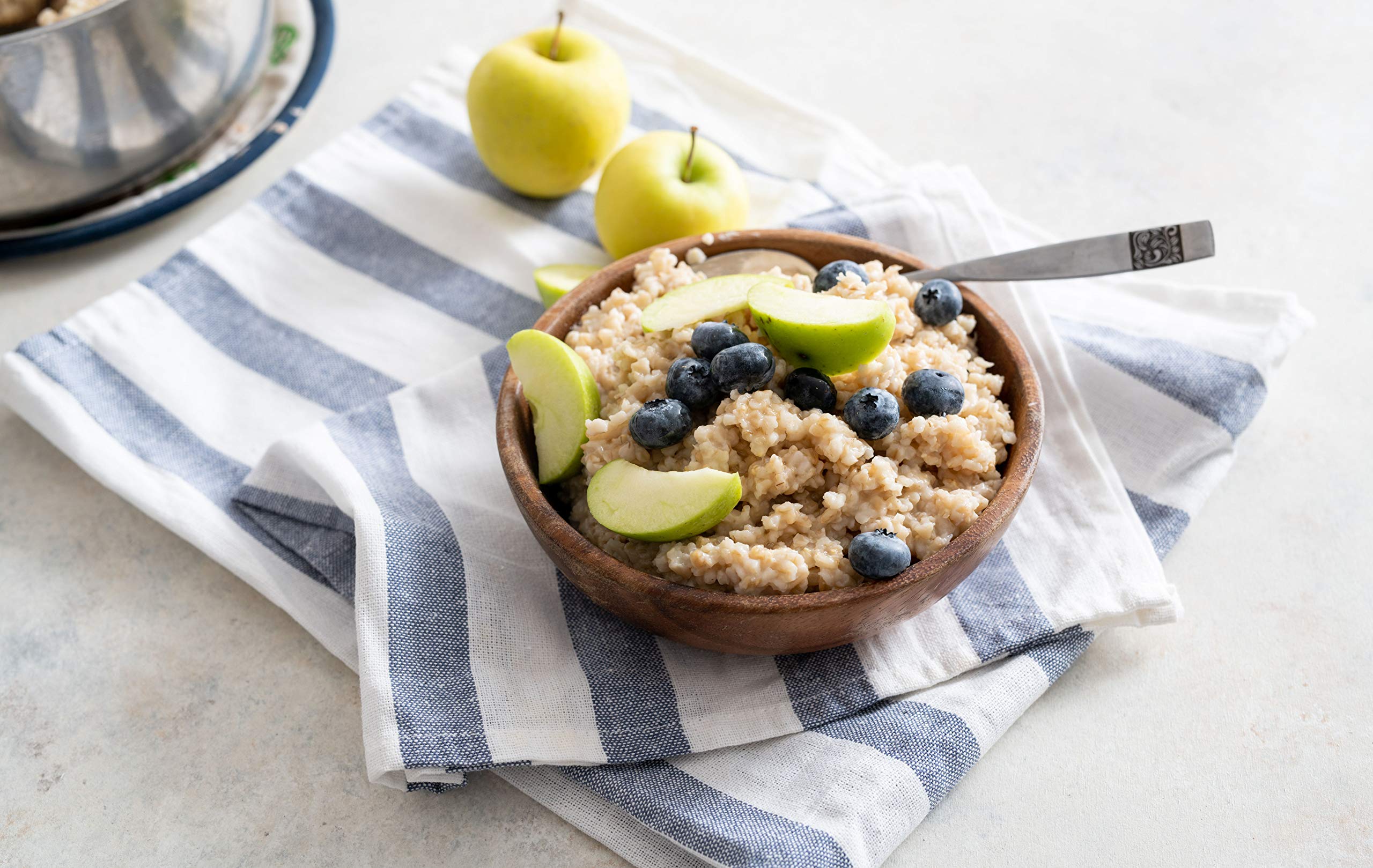 Bob's Red Mill steel cut oats pour into a pot, ready to simmer.