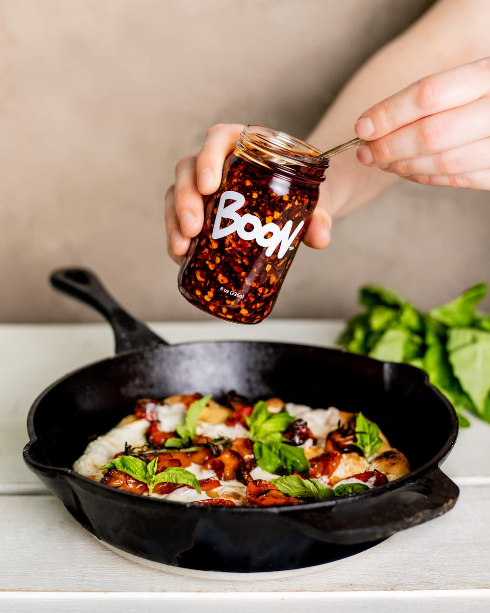 Boon Sauce Chili Oil ingredient close-up shows garlic, shallots and chilis for vibrant flavor.