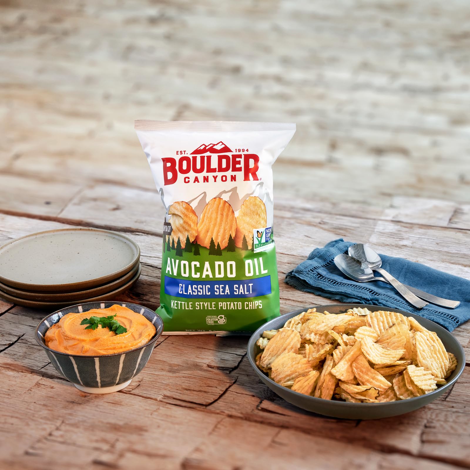 Boulder Canyon sea salt chips paired with dip, inviting quick snack moments.