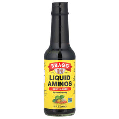 Bragg Liquid Aminos bottle pour adds savory umami to meals.