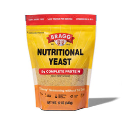 Bragg nutritional yeast original packaging on kitchen counter, highlighting vegan parmesan substitute savory.