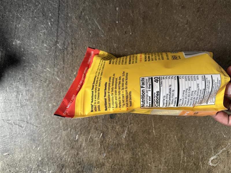 Close-up of Bragg nutritional yeast texture in a spoon.