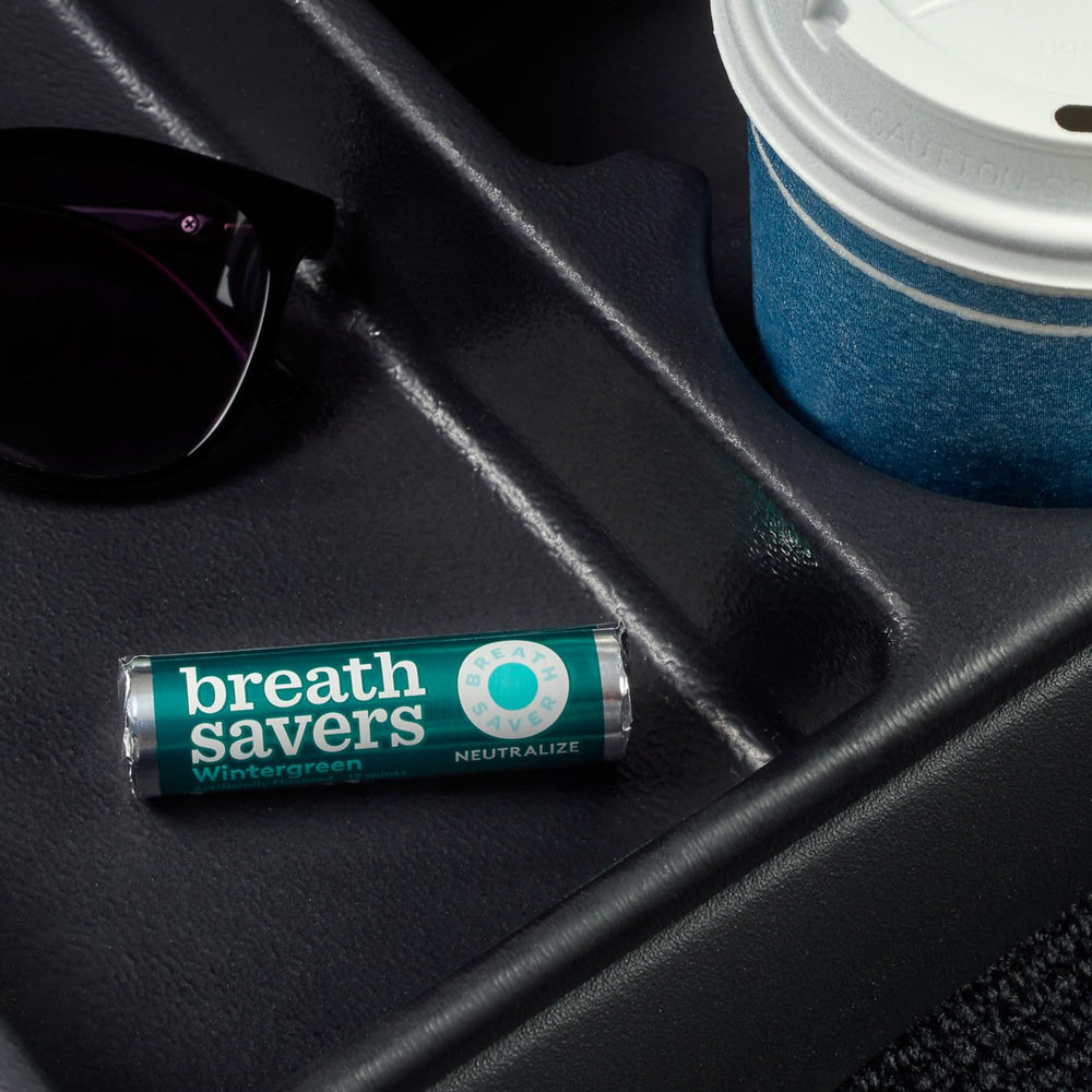 Breath Savers Wintergreen mints packaging open, showing twenty four rolls.