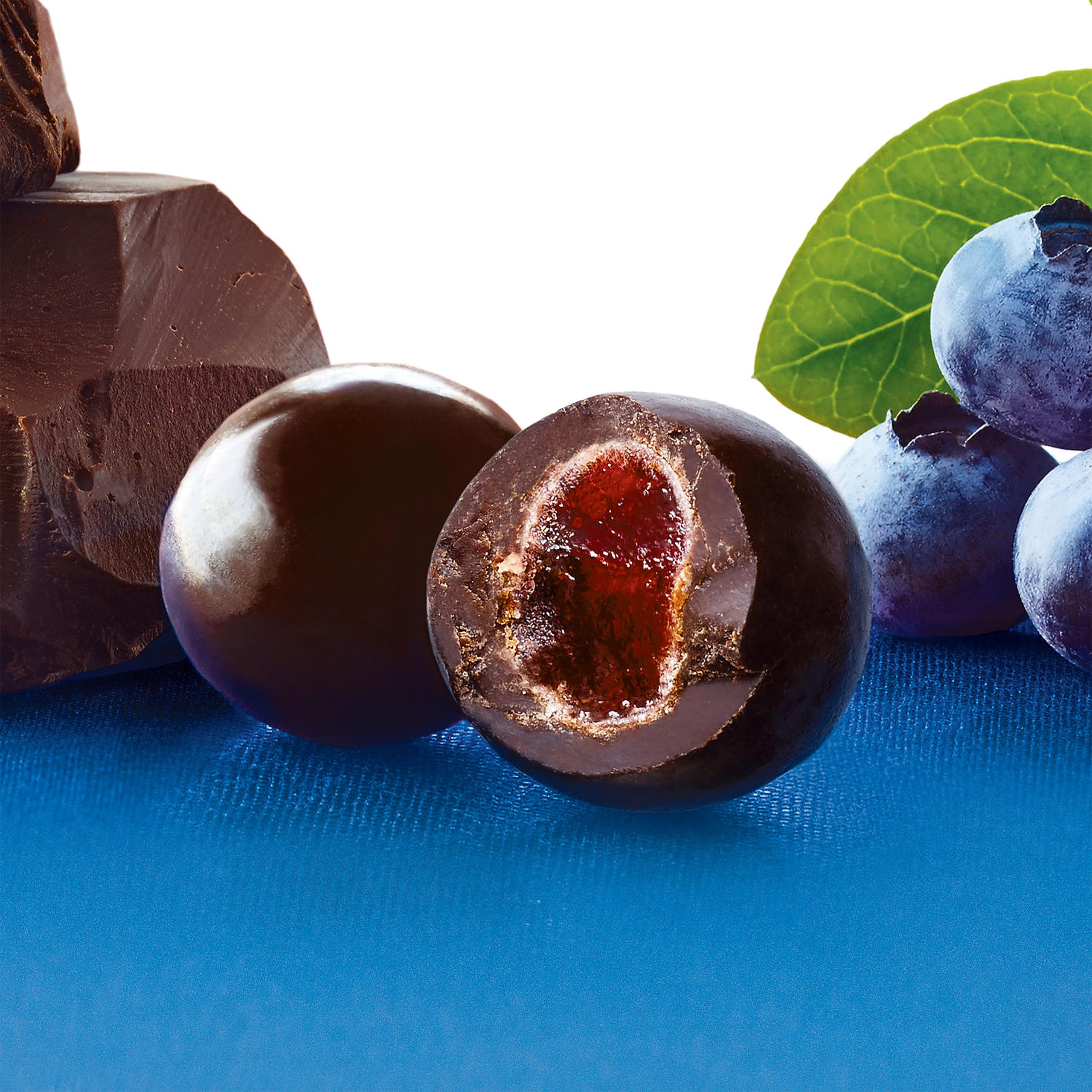 Close-up of Brookside acai blueberry centers with smooth chocolate coating, fruity contrast.